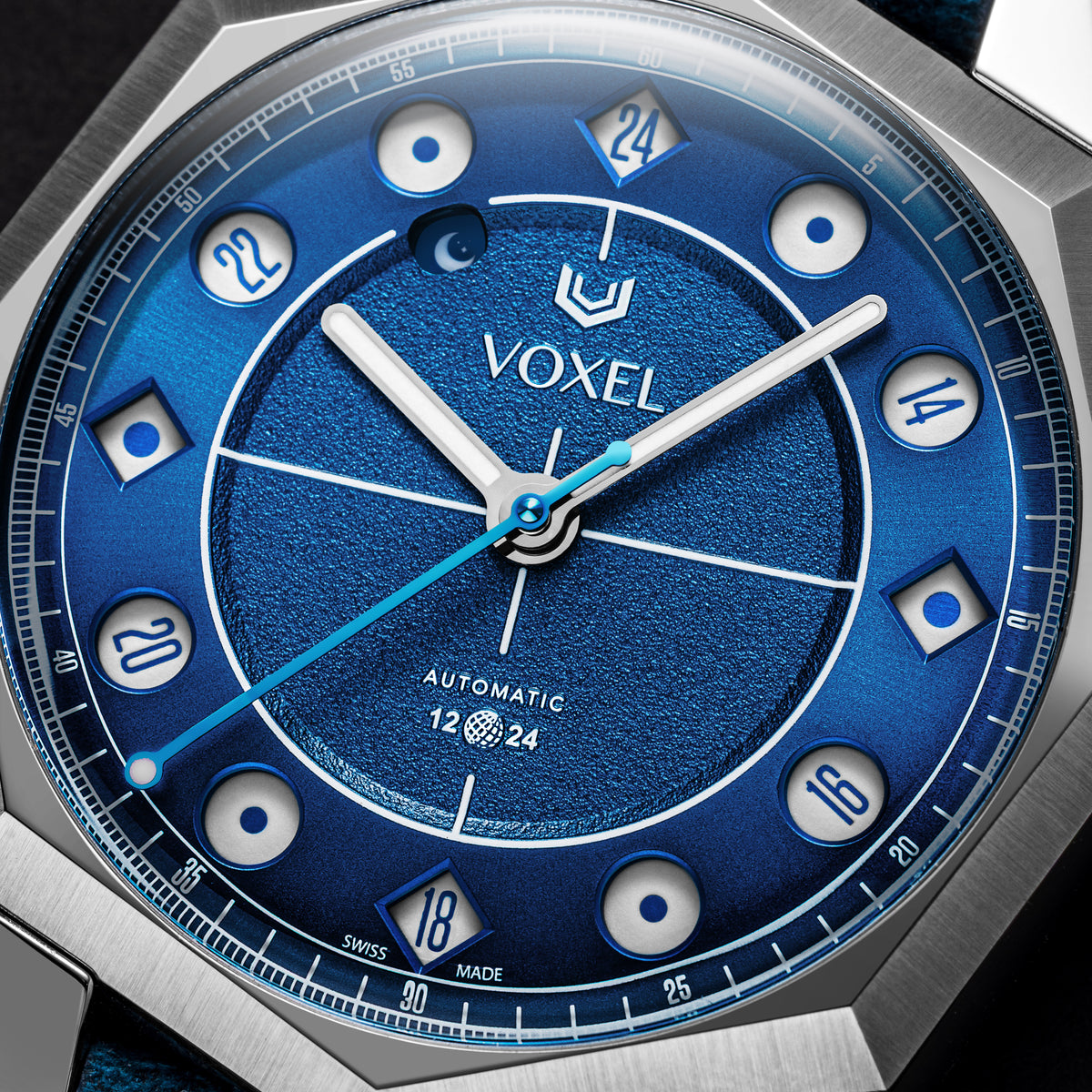 Close-up of the VOXEL Meridion Electric Blue Dial in 24-hour mode, showing the jumping-hours apertures, textured centre and light blue seconds hand