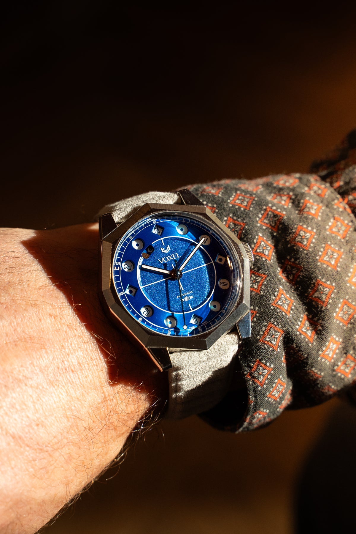 VOXEL Meridion Electric Blue Dial worn on the wrist with a grey Alcantara strap