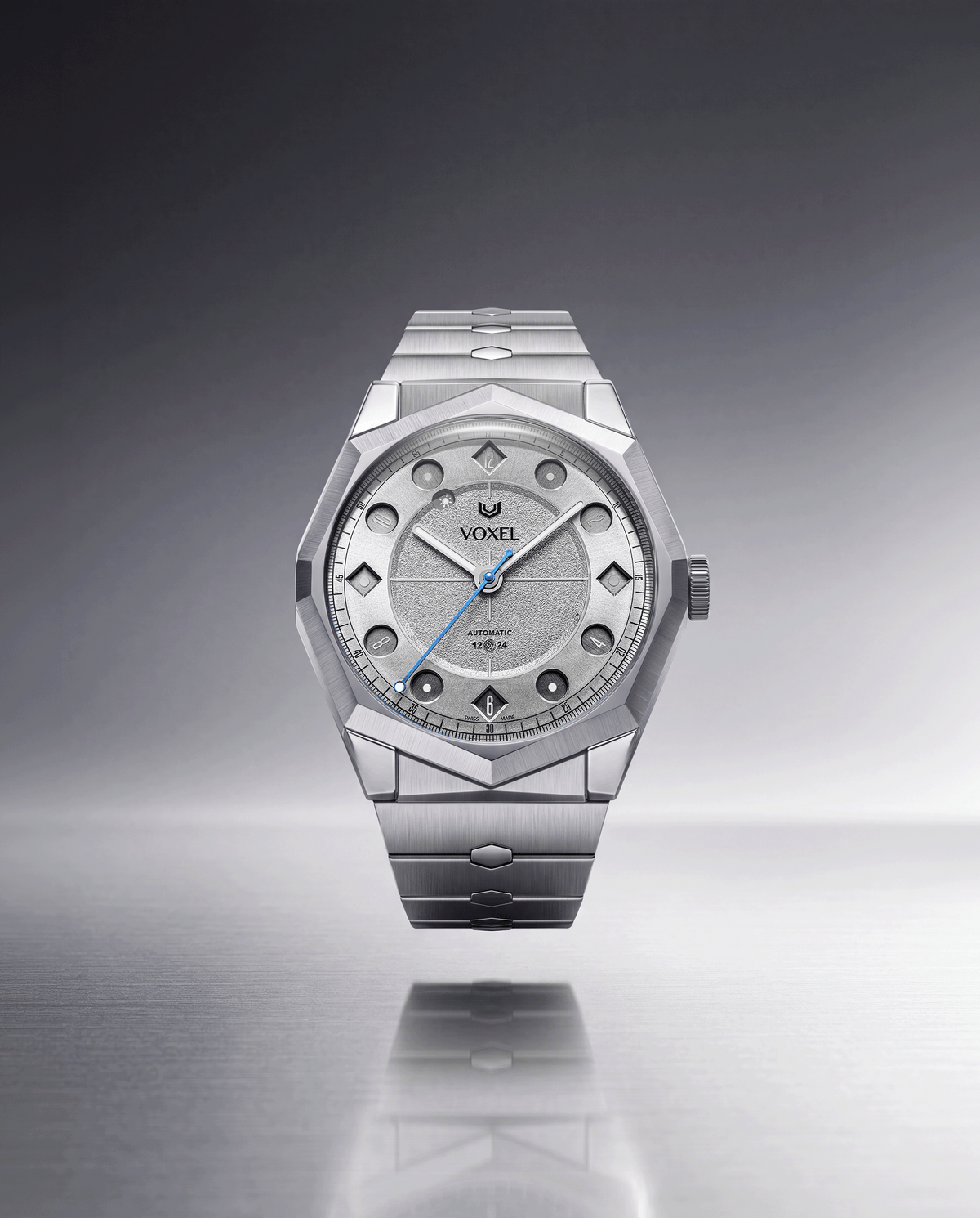 VOXEL Meridion Silver Star Dial automatic watch on integrated 904L steel bracelet, front view on a reflective grey background