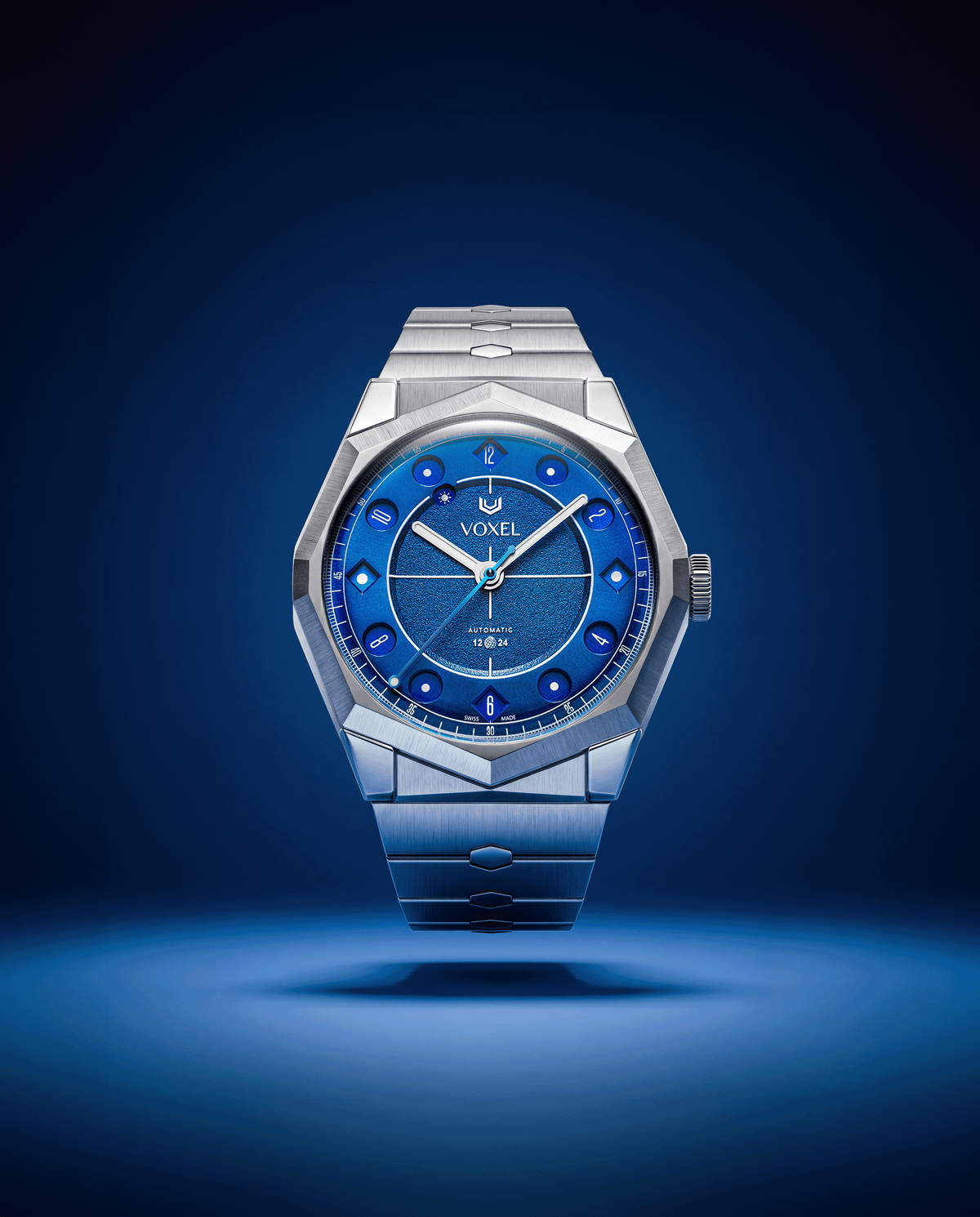 VOXEL Meridion Electric Blue Dial on integrated 904L steel bracelet, front view under blue light