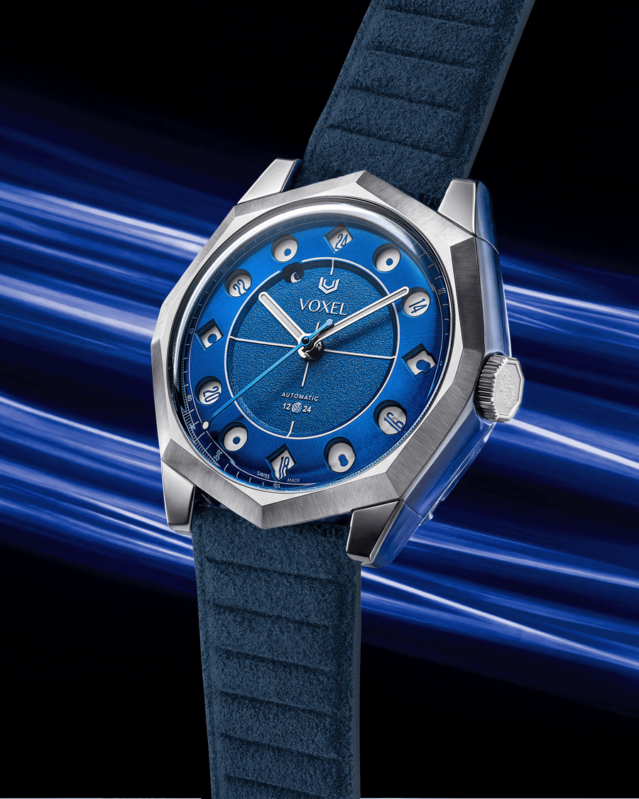 VOXEL Meridion Electric Blue Dial automatic watch with dark blue Alcantara strap, three-quarter view in 24-hour mode with blue light trails